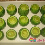 Remove the seeds and some of the flesh in the zucchinis and place them on the greased baking dish.